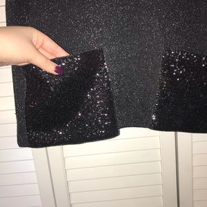 Slightly cropped black blouse with sparkle pockets